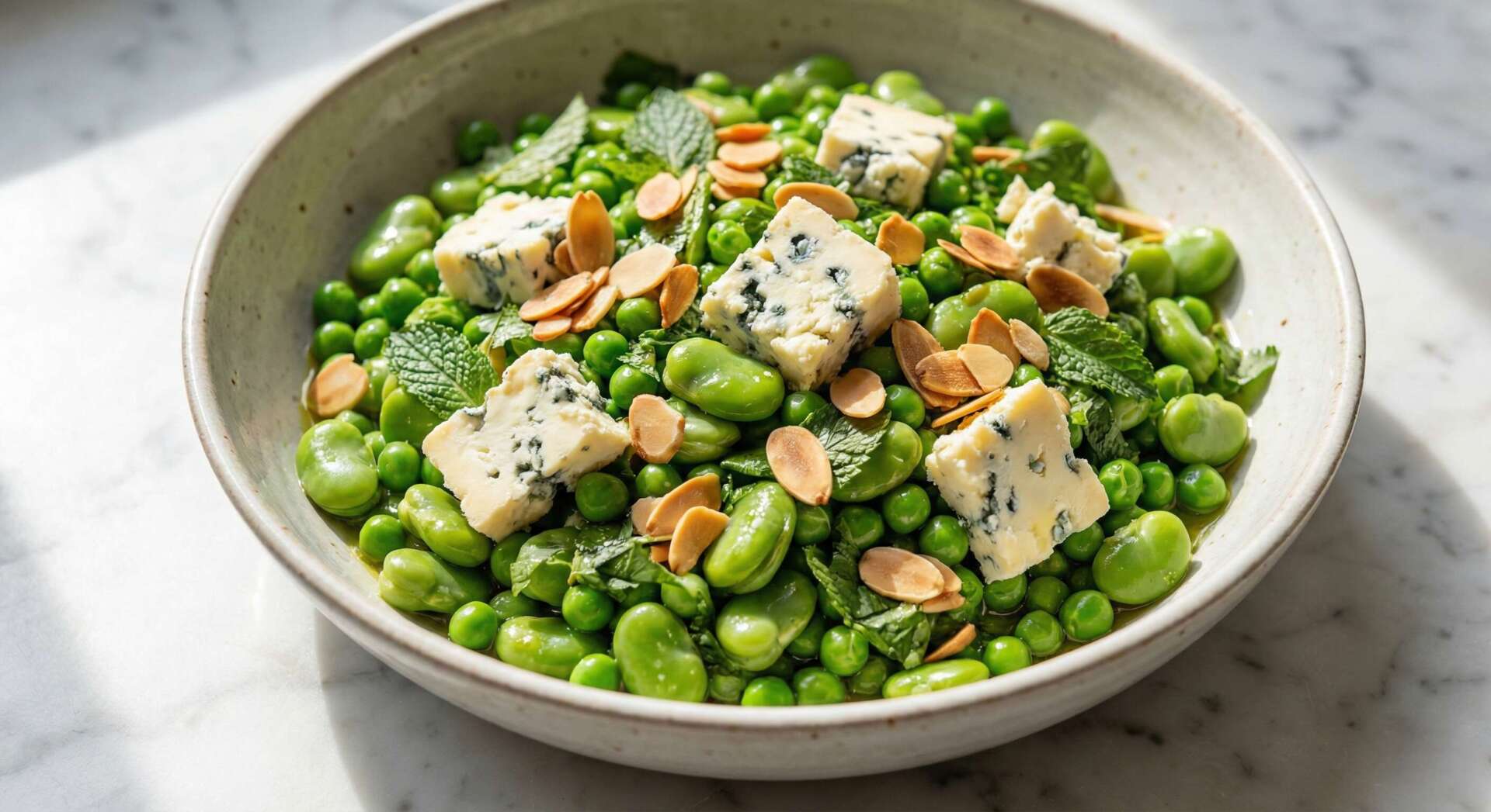 Bowl of peas and broad beans with Cashel Blue and toasted almonds