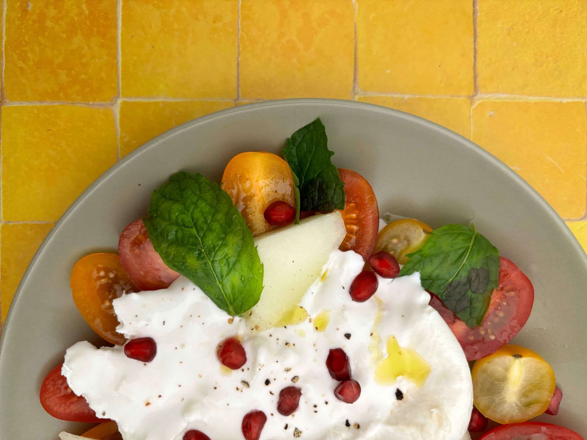 Tomato, Melon, Pomegranate, and Burrata Salad