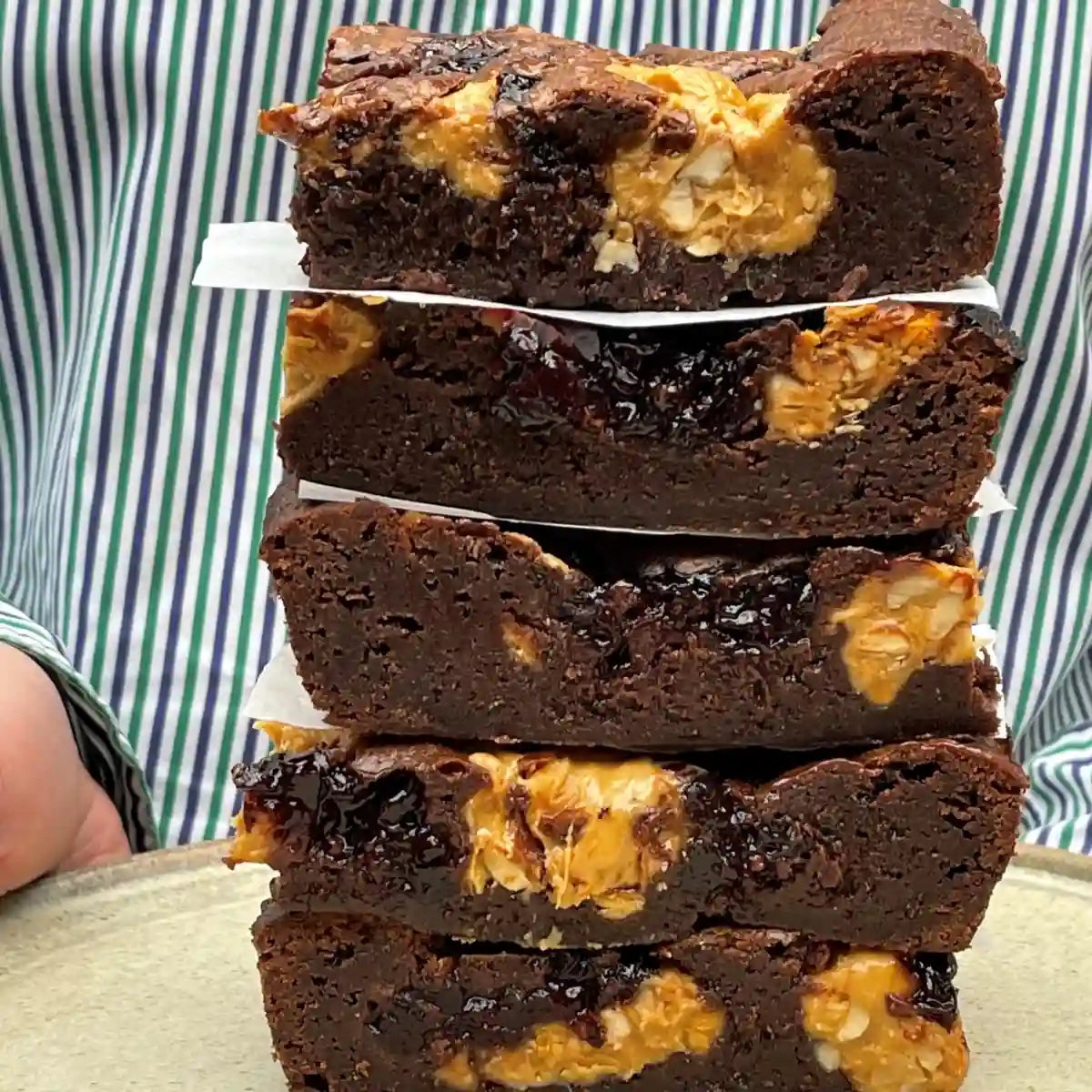Stack of chocolate brownies with morello cherries