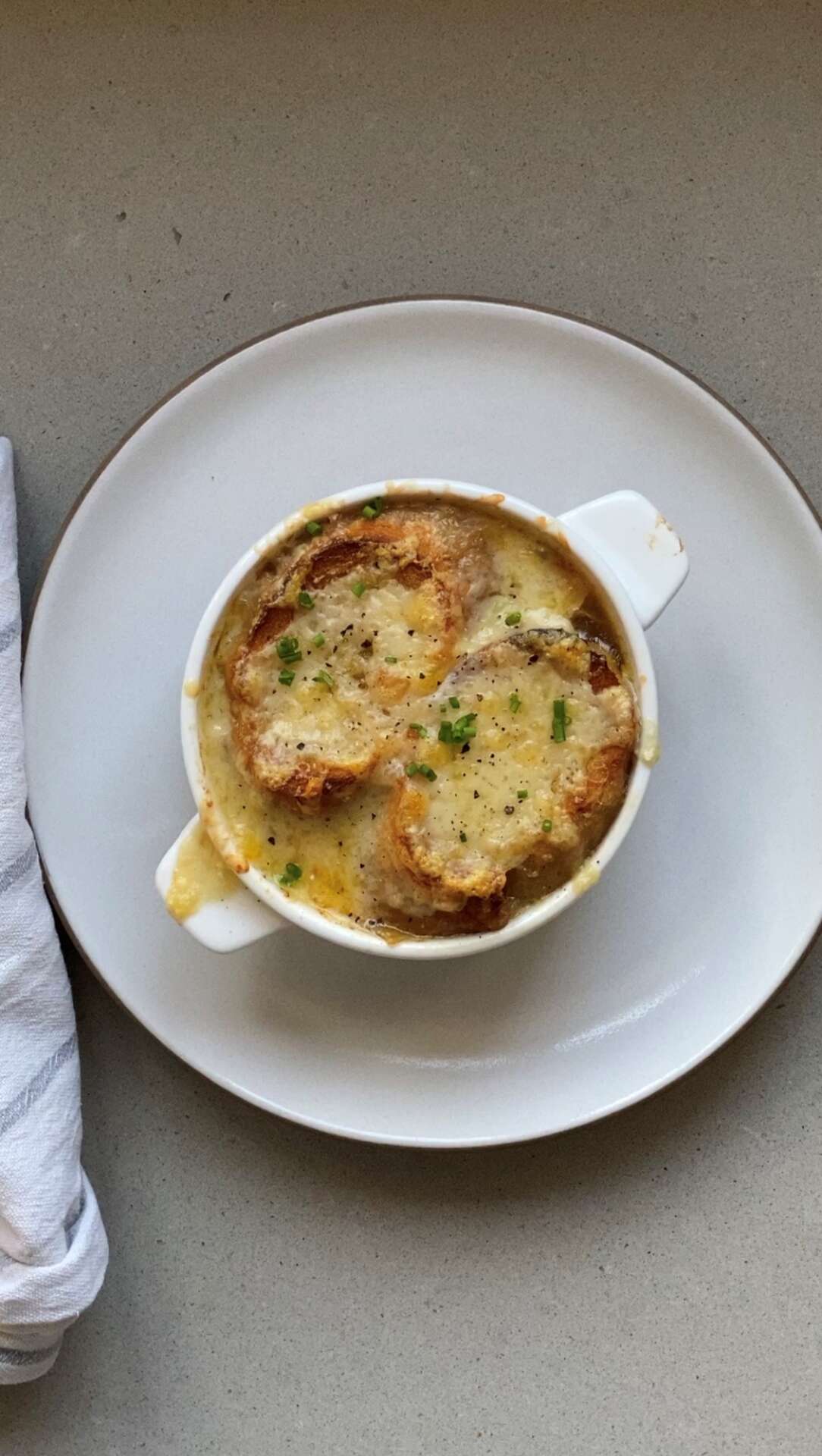 Bowl of French onion soup gratinée with a cheese crust