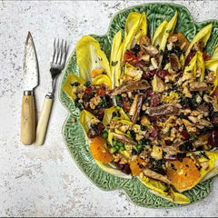 Chicory and squash salad with walnuts on a green leaf shaped plate