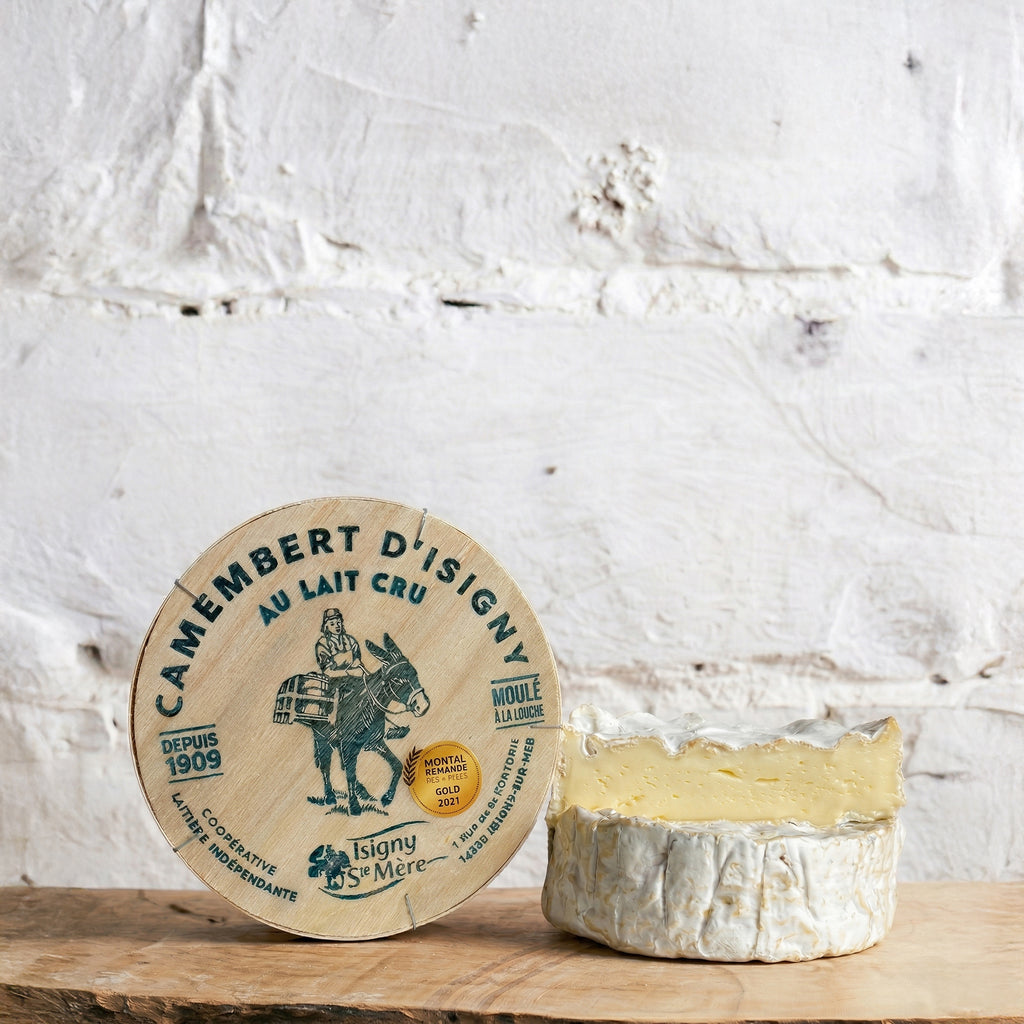 Camembert cheese with a wooden board on a rustic white background