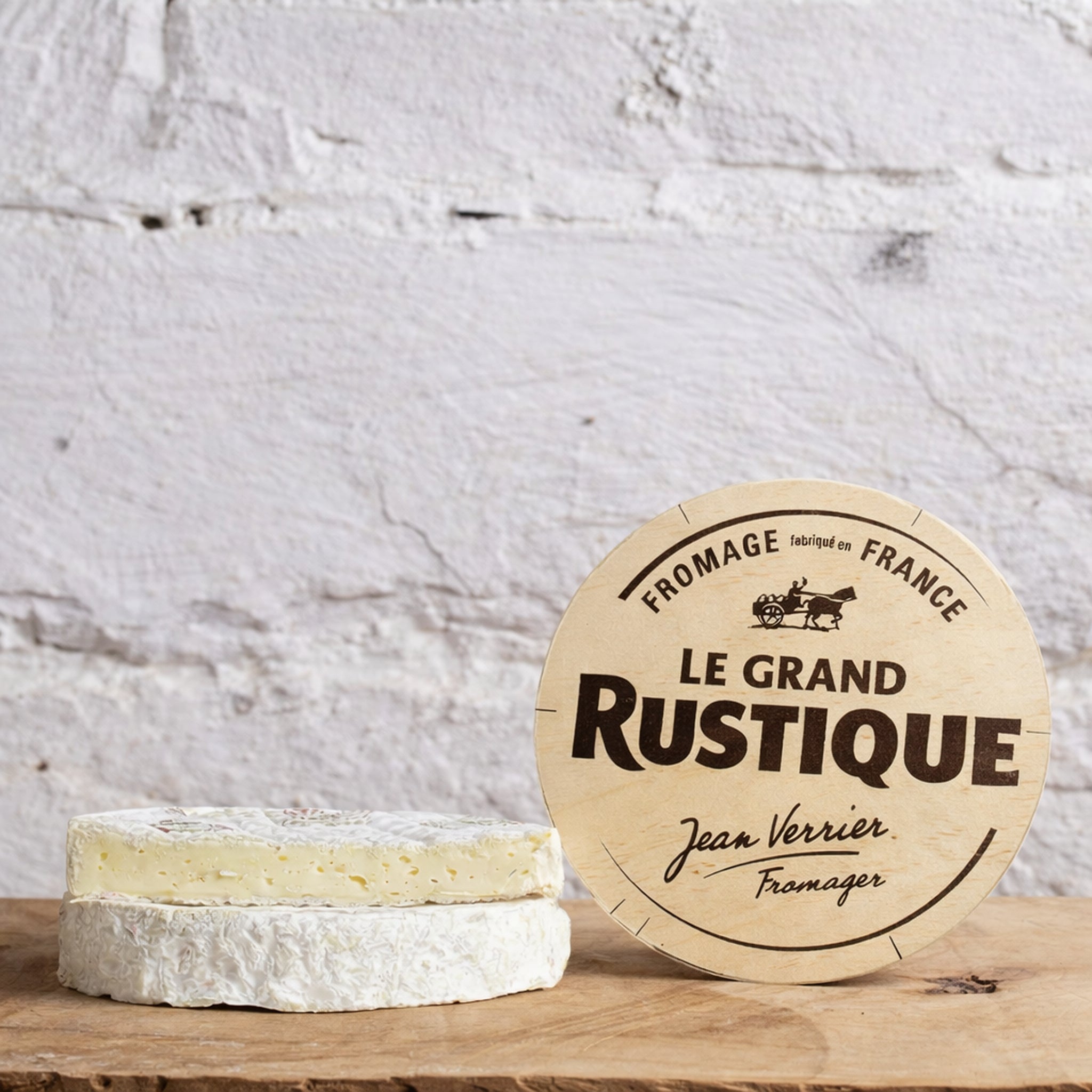 Le Grand Rustique cheese with a wooden sign on a rustic background