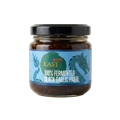 Jar of 100% Fermented Black Garlic Paste with 'EAST' branding on a white background
