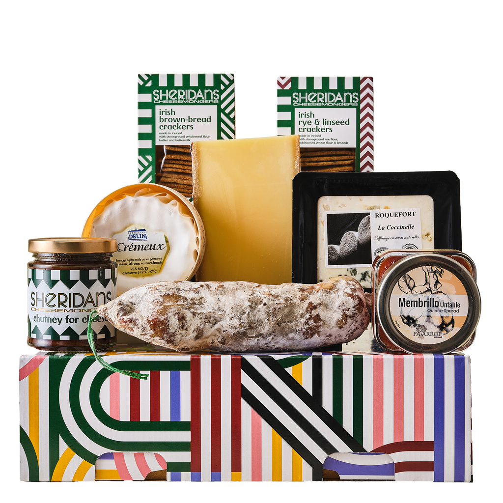 Assorted food items including cheese, salami, and crackers on a colorful box with Sheridan's branding.