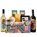 Gift basket with Sheridan wine bottles, cheese, and other snacks on a white background