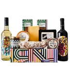 Gift basket with Sheridan wine bottles, cheese, and other snacks on a white background