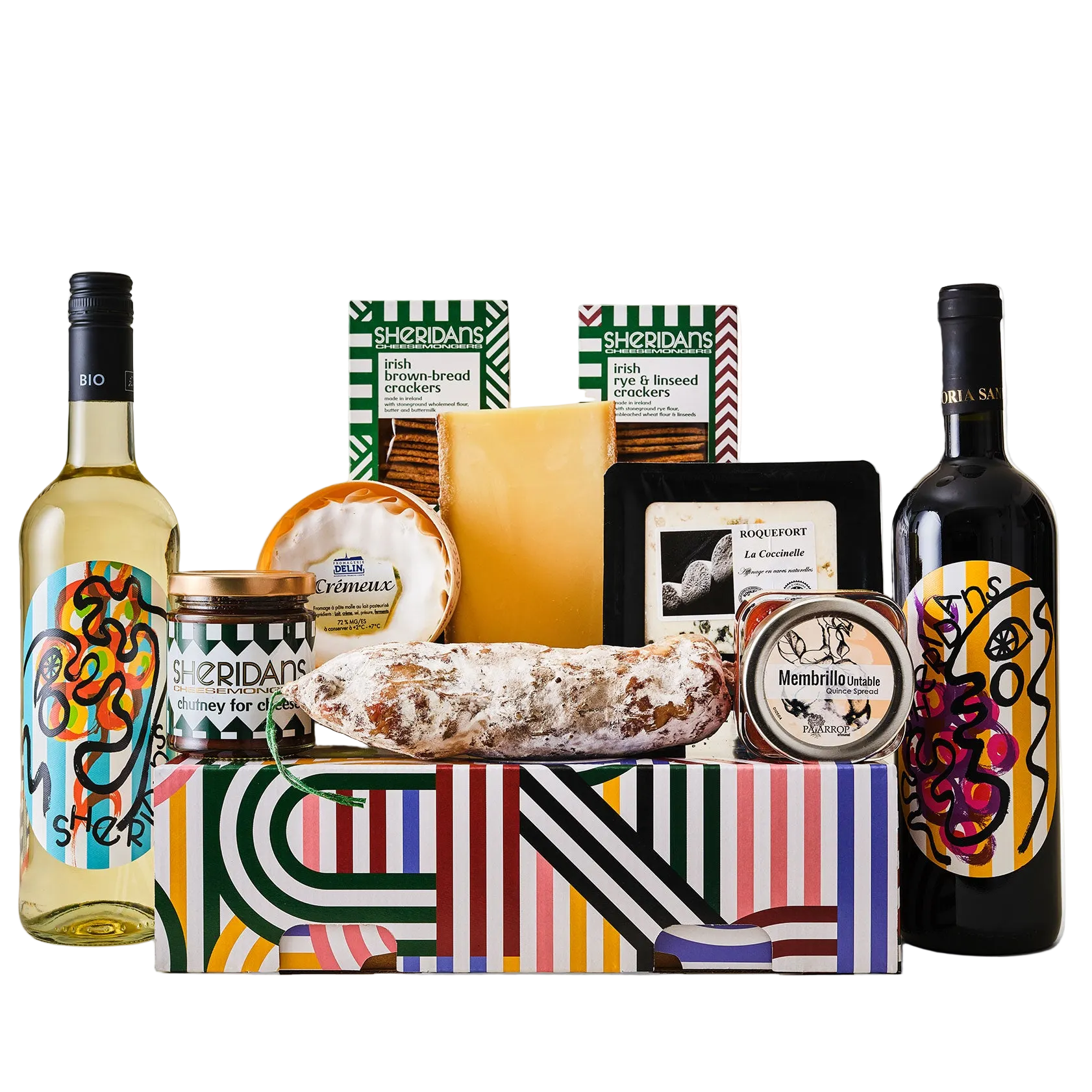 Gift basket with Sheridan wine bottles, cheese, and other snacks on a white background