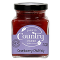 Jar of cranberry chutney with a purple label on a white background