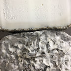 Close-up of a textured stone surface with a white background