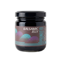 Jar of balsamic jelly with a decorative label on a white background