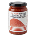 Jar of organic crushed tomatoes with garden vegetables on a white background
