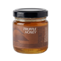 Jar of truffle honey with a black lid on a white background