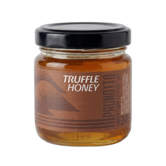 Jar of truffle honey with a black lid on a white background
