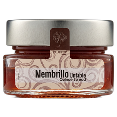 Jar of Membrillo Untable Quince Spread with a silver lid on a white background
