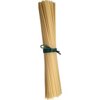 Bunch of uncooked spaghetti tied with a green rubber band on a white background