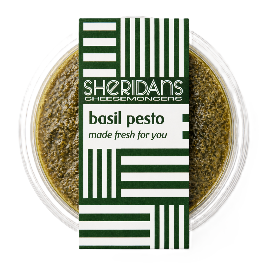 Bowl of basil pesto with Sheridan's Cheesemongers label on a white background