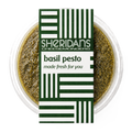 Bowl of basil pesto with Sheridan's Cheesemongers label on a white background