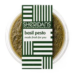 Bowl of basil pesto with Sheridan's Cheesemongers label on a white background