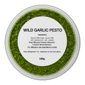 Container of wild garlic pesto with a label on a white background