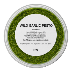 Container of wild garlic pesto with a label on a white background