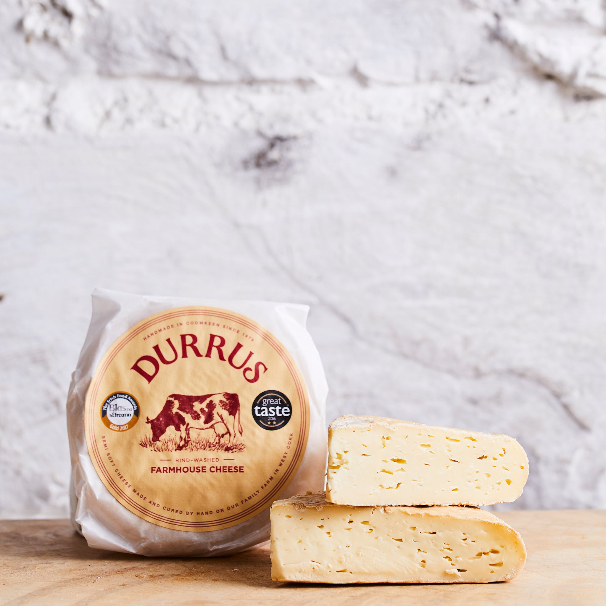 Durrus farmhouse cheese on a wooden board with a marble background