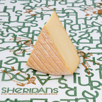 Triangle of cheese on a Sheridan's Cheesemongers branded paper