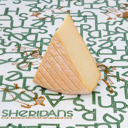 Triangle of cheese on a Sheridan's Cheesemongers branded paper