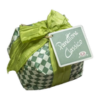 A wrapped gift box with a green and white checkered pattern, tied with a large lime green satin bow and featuring a tag that reads 'Panettone Classico'.