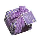 Decorative package with a purple bow and checkered pattern on a white background