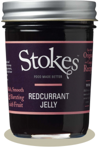 A jar of Stokes Redcurrant Jelly with a dark purple label and silver lid, shown on a white background with a soft shadow.