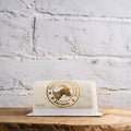 Rolled cheese product with P. Jacquin logo on a wooden surface and white brick wall background